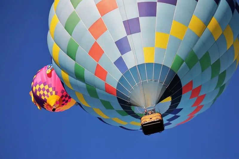 Two colorful hot air balloons flying in the sky.