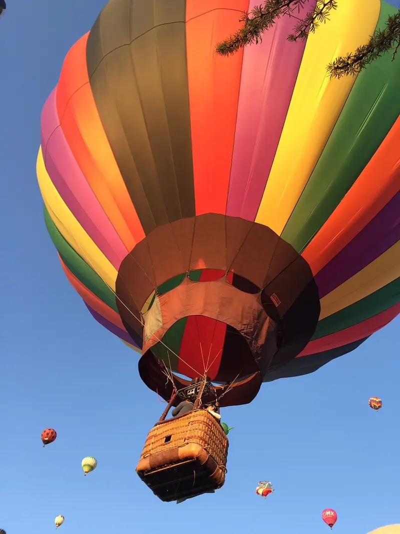 A colorful hot air balloon flying in the sky.