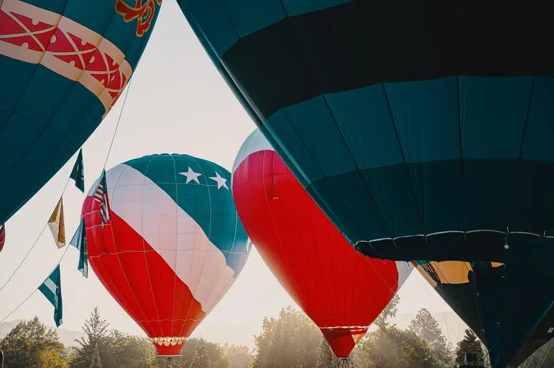 A group of hot air balloons flying in the sky.