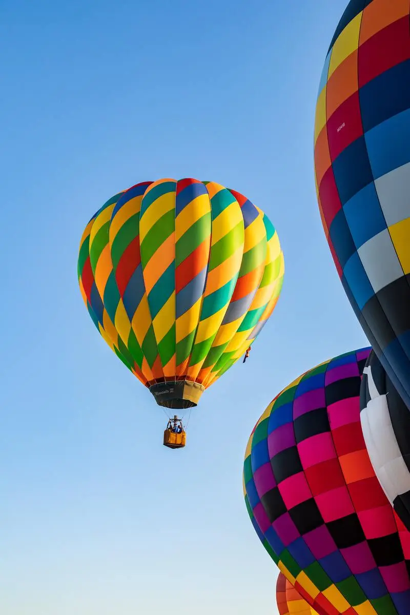 A group of colorful hot air balloons flying in the sky.