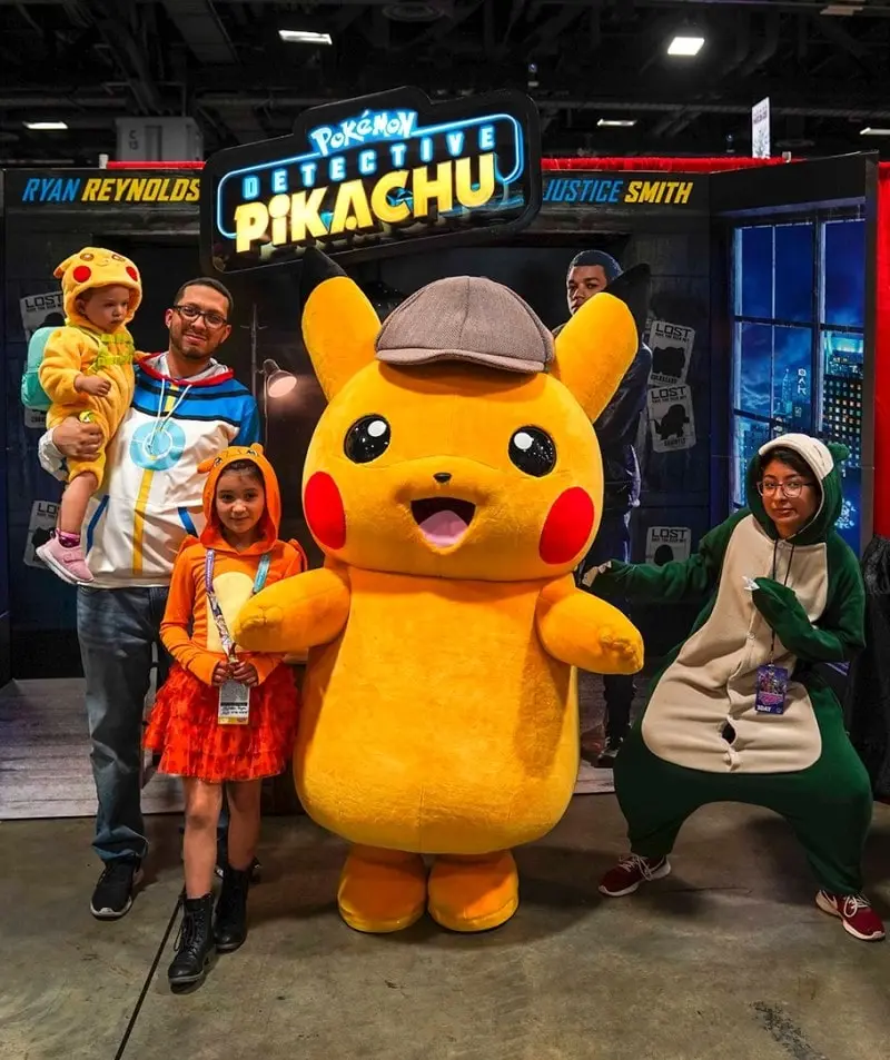 kids posing with Pikachu in costume