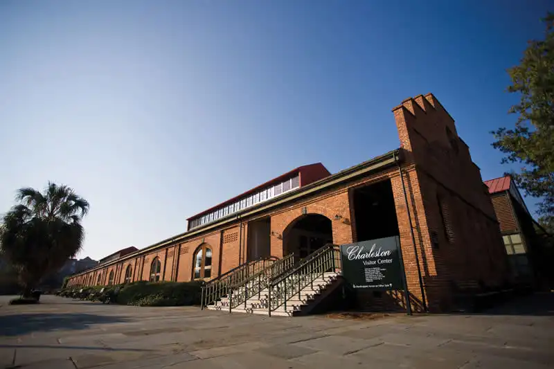 A brick building with a palm tree in front of it.