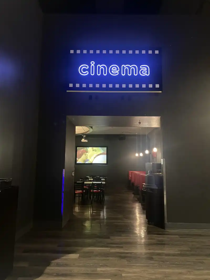 The entrance to Jake's Unlimited movie theater with a sign that says cinema.