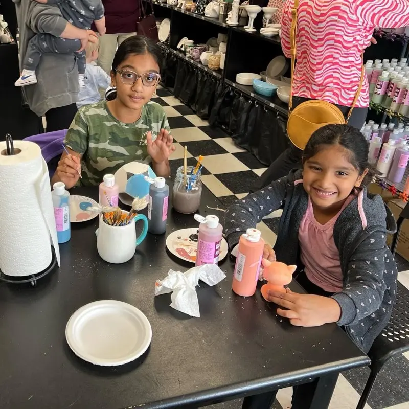 Kids at table painting their own pottery