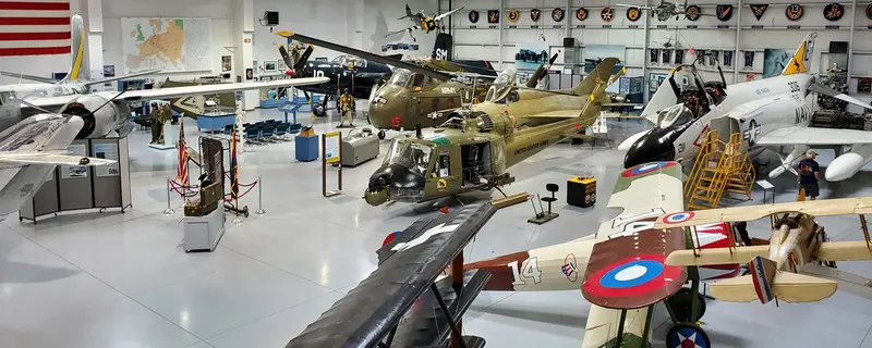 A collection of military planes in a museum.