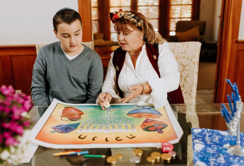 young adult playing board game with his mother