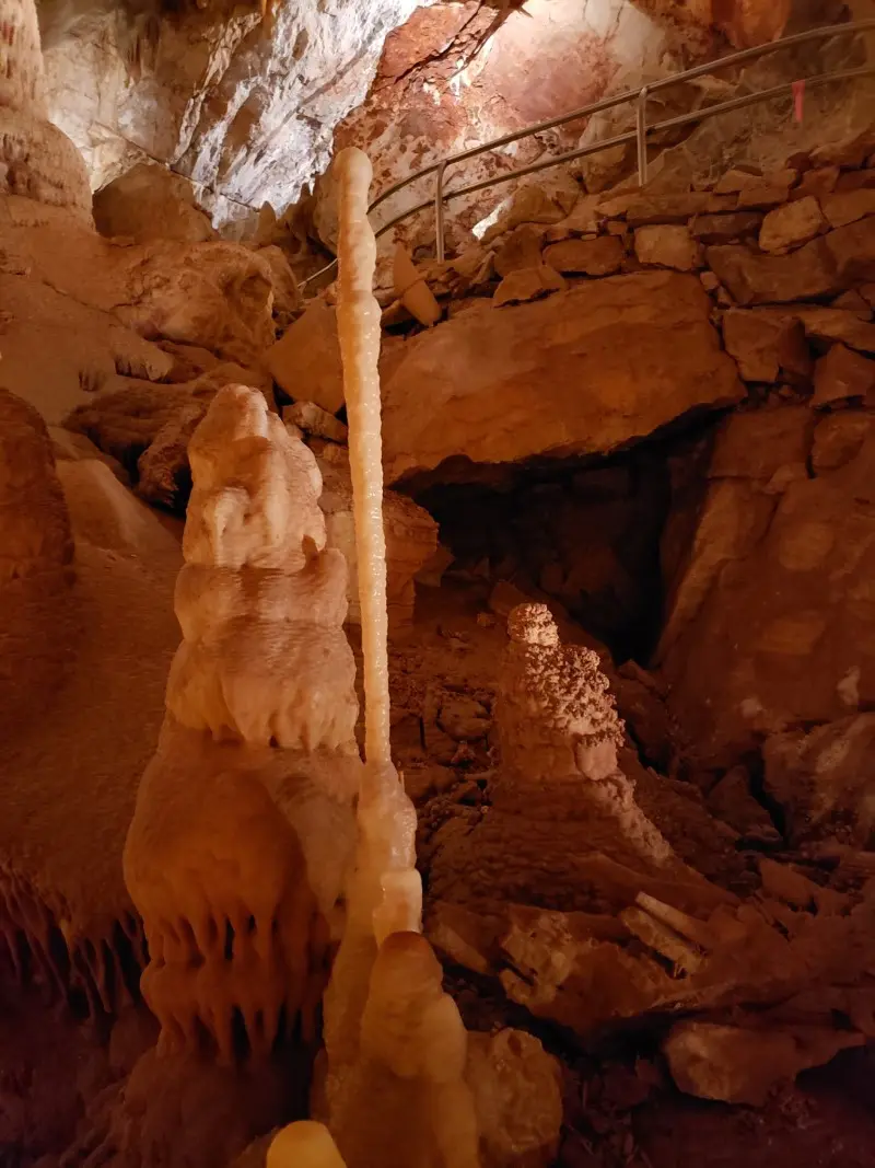 A cave with an abundance of stalactites and stalagmites, resembling Kartchner Caverns.