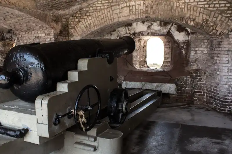 An old cannon sits inside a brick building at Fort Sumter.