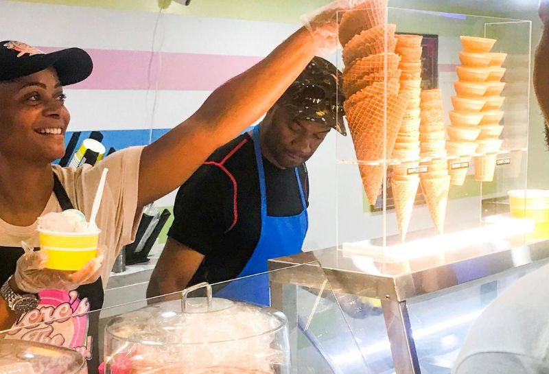 woman serving ice cream to customers