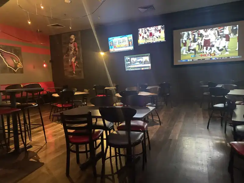 Jake's Unlimited: A sports bar with tables and chairs, featuring a TV on the wall.