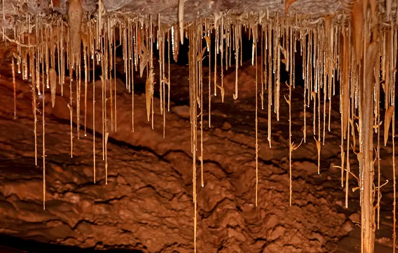A cavern with icicles hanging from the ceiling, like Kartchner Caverns.