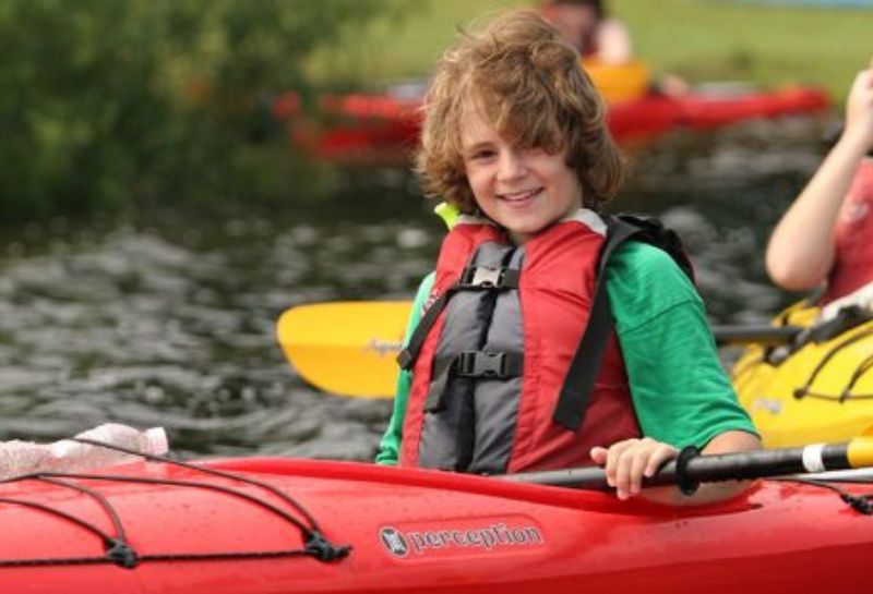 Kid kayaking at Key Bridge Boathouse website