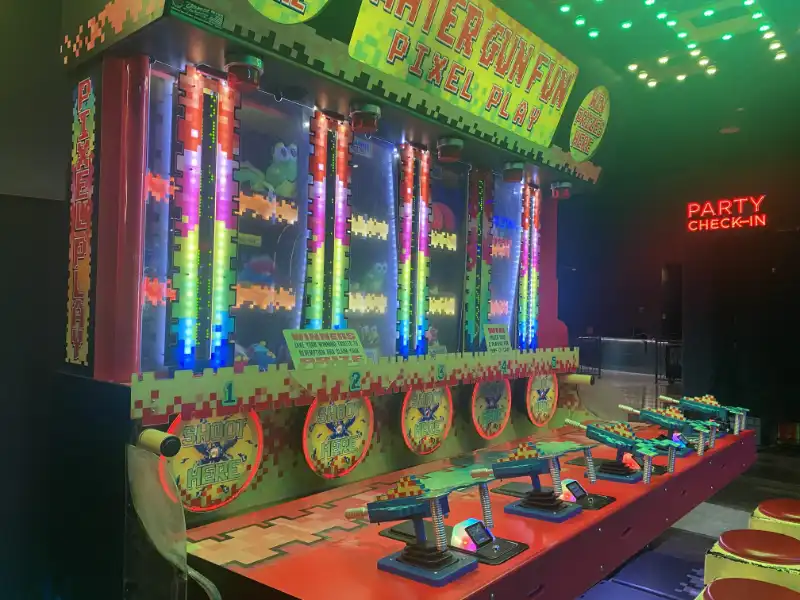 Jake's Unlimited: A game machine with colorful lights in the background.
