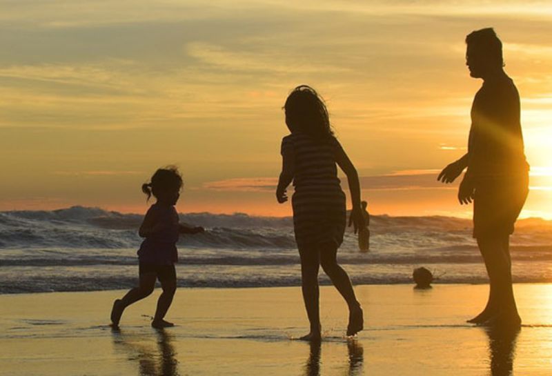 A family having fun at the beach in the evening