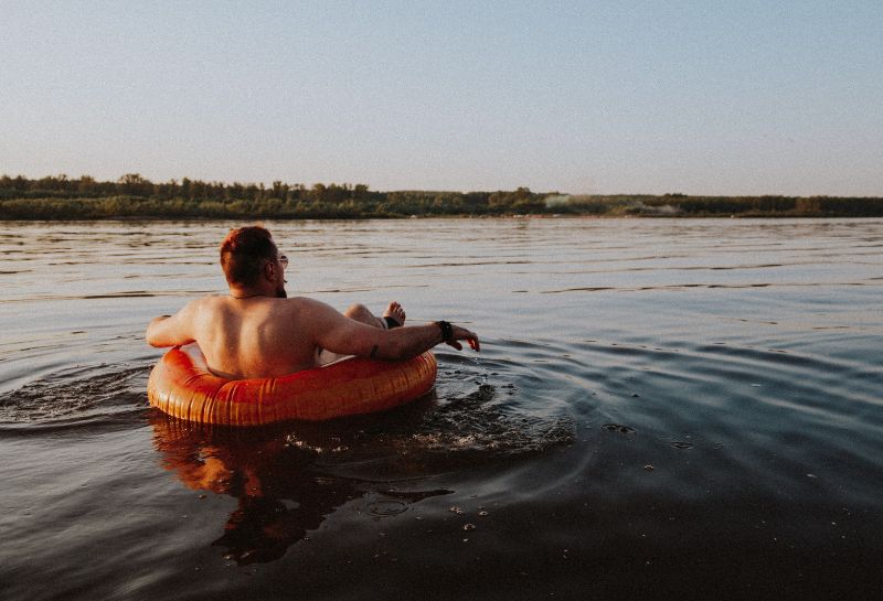 Topless man in brown inflatable river