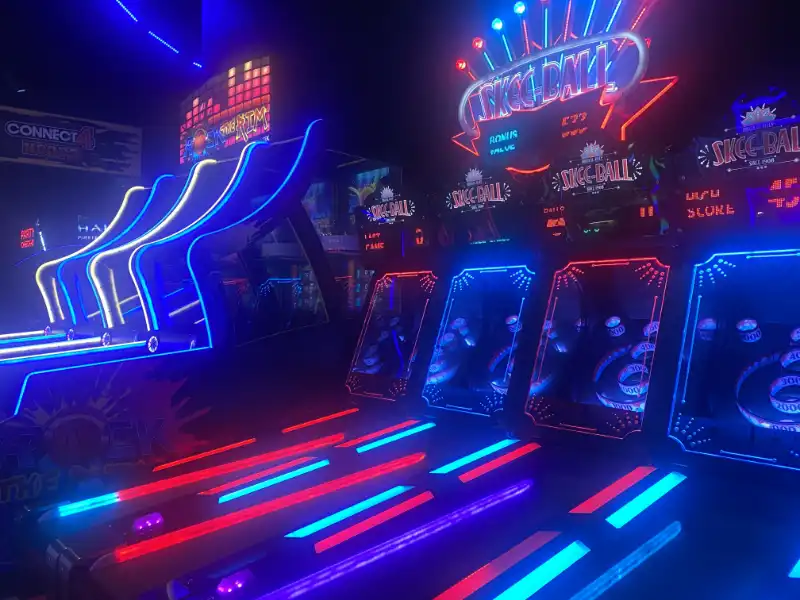 Neon-lit skee ball game at Jake's Unlimited.