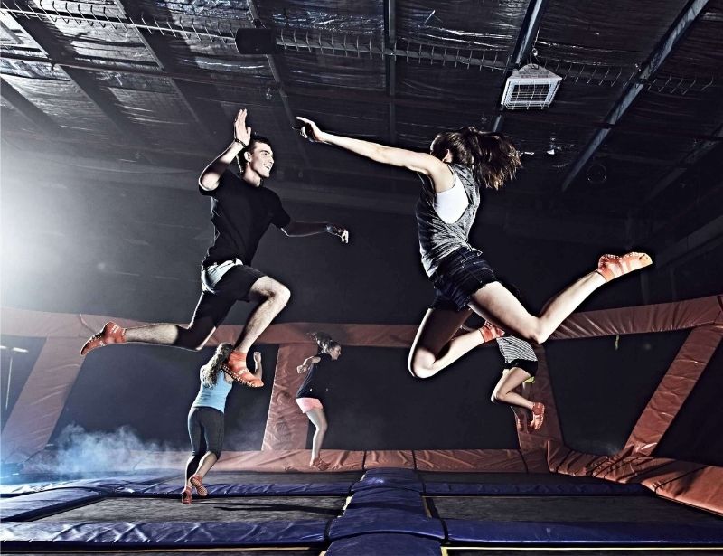 youth couple jumping on a trampoline