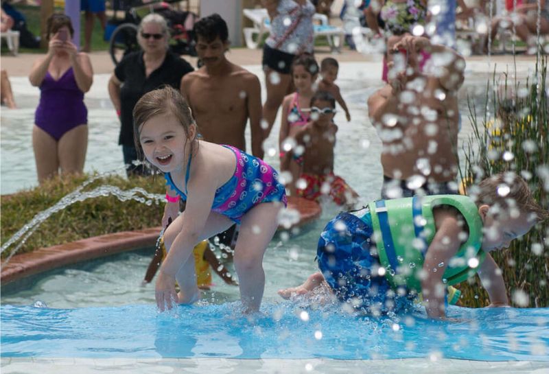 Toddler playing in water at a waterpark