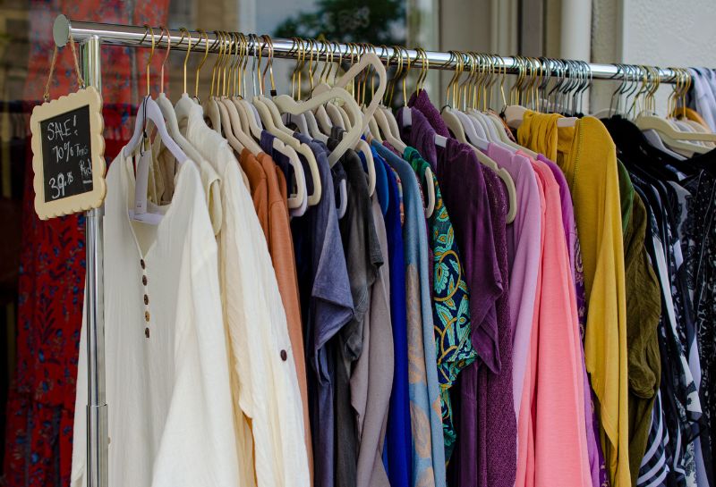 Shirts hanging on a hanger for sale at a thrift store