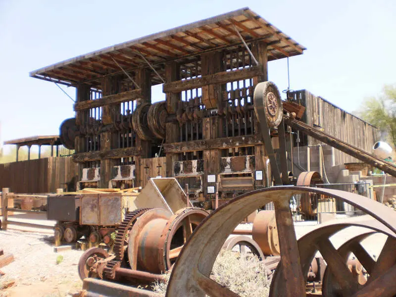 A group of old rusty machines in a desert setting.