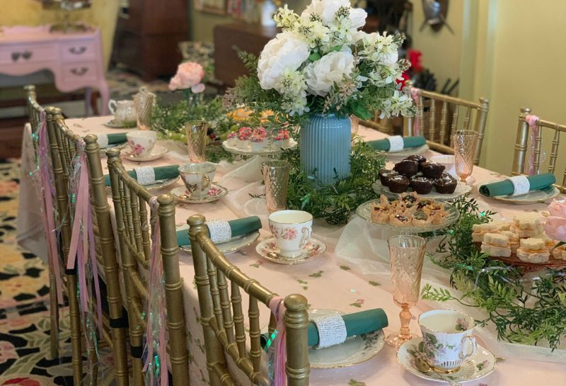 tea table adorned with flowers and vintage tea cups