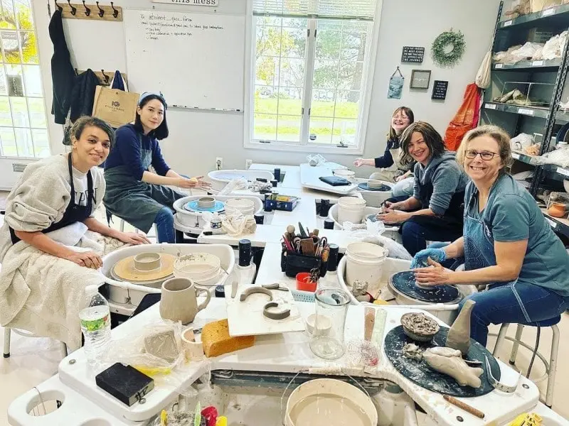 women painting pottery